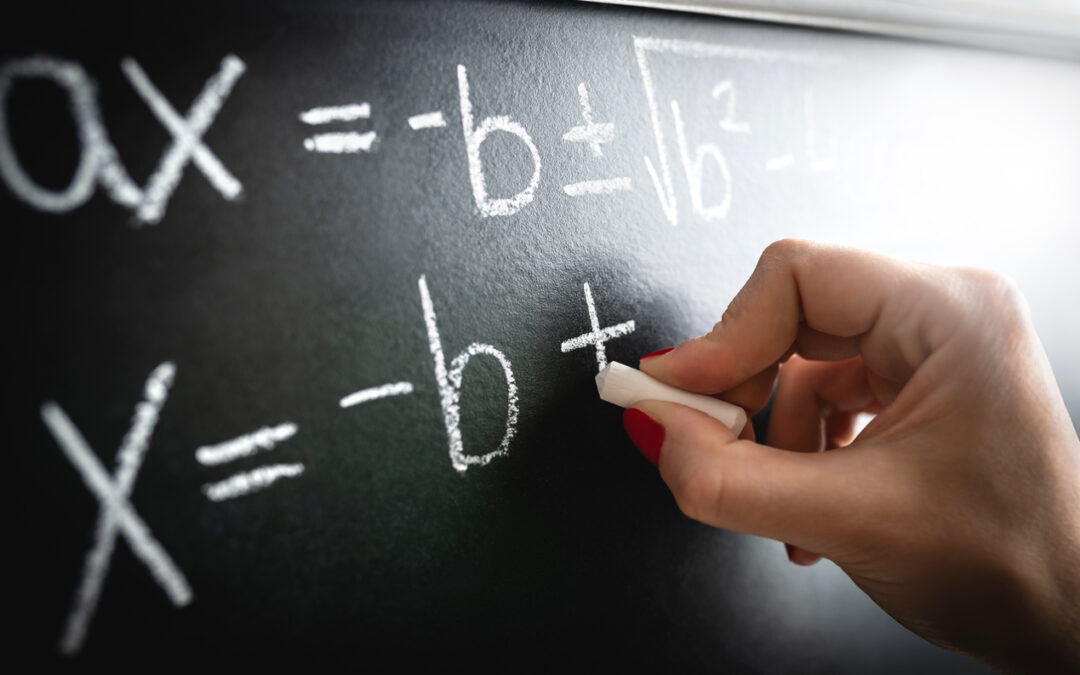 Math equation, function or calculation on chalkboard. Teacher writing on blackboard during lesson and lecture in school classroom. Student or tutor calculating.
